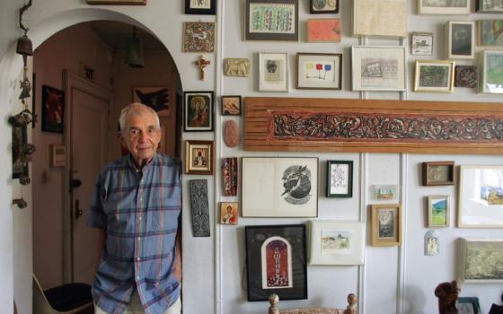 Jesuit Fr. Daniel Berrigan, then 85, poses in his New York City apartment in 2006. Berrigan died in 2016 at age 94. (CNS/Todd Plitt)