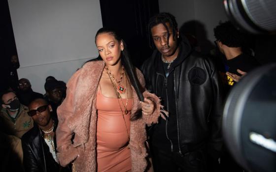 Rihanna, left, and ASAP Rocky arrive for the Off-White Ready To Wear Fall/Winter 2022-2023 fashion collection, unveiled during Fashion Week in Paris Feb. 28. Rihanna's pregnancy became public Jan. 31 with a photo of her baring her baby bump. (AP/Invision/