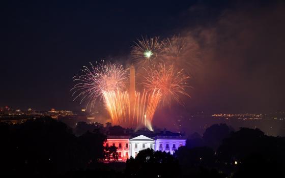 Fireworks appear above the White House North Portico, lit in red, white and blue lights, July 4, 2020, during the Salute to America Fourth of July celebration. (Official White House photo/Keegan Barber)