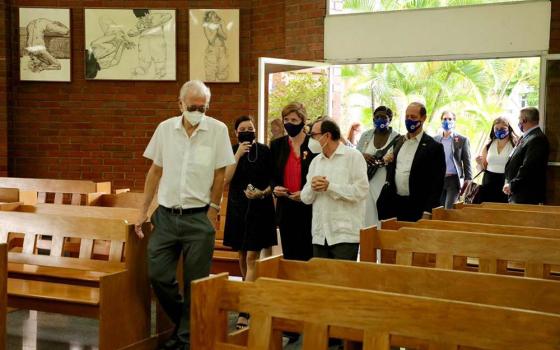 Samantha Power (in red shirt), head of USAID, visits the chapel at Central American University in San Salvador, El Salvador, June 14. (Flickr/USAID)