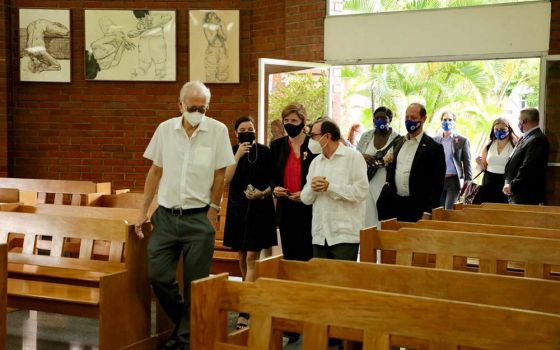 Samantha Power (in red shirt), head of USAID, visits the chapel at Central American University in San Salvador, El Salvador, June 14. (Flickr/USAID)