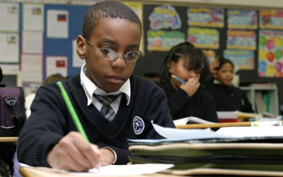 Fourth-grader Richard Blount works on a social studies assignment at Our Lady of Lourdes School in Massapequa Park, N.Y., Jan. 14, 2004. At the time, more than 2.5 million students were enrolled in 8,000 Catholic schools in the U.S.