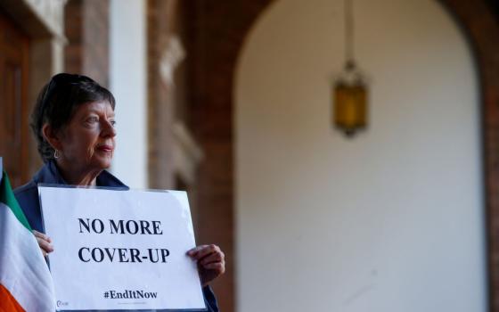 A woman demonstrates inside the headquarters of Benedictine order in Rome Feb. 22, 2019, during a four-day meeting on the protection of minors in the church at the Vatican. (CNS/Reuters/Yara Nardi)