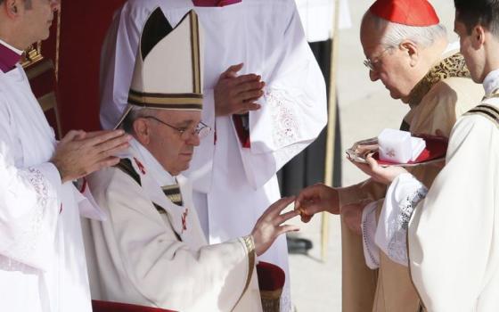 Pope Francis receives his ring from Cardinal Angelo Sodano, dean of the College of Cardinals, during his inaugural Mass in St. Peter's Square at the Vatican March 19, 2013. (CNS/Paul Haring)