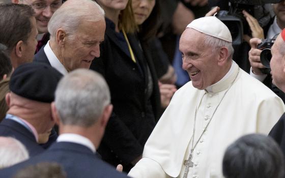 In this April 29, 2016, file photo Pope Francis shakes hands with Vice President Joe Biden as he takes part in a congress on the progress of regenerative medicine and its cultural impact, being held in the Pope Paul VI hall at the Vatican. (AP Photo/Andre