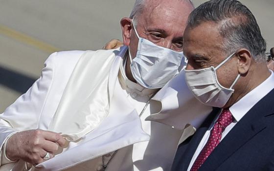 Pope Francis is greeted by Iraqi Prime Minister Mustafa al-Kadhimi as he arrives at Baghdad's international airport, Iraq, on March 5, 2021. (AP Photo/Andrew Medichini)