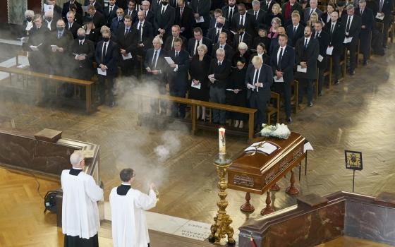 British Prime Minister Boris Johnson, right in front row, attends a Requiem Mass for slain member of parliament David Amess, inside Westminster Cathedral, central London, Tuesday, Nov. 23, 2021. (Stefan Rousseau/Pool Photo via AP)