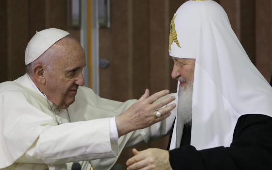 Pope Francis, left, reaches to embrace Russian Orthodox Patriarch Kirill after signing a joint declaration at the Jose Marti International airport in Havana, Cuba, Friday, Feb. 12, 2016. (AP Photo/Gregorio Borgia, Pool, File)