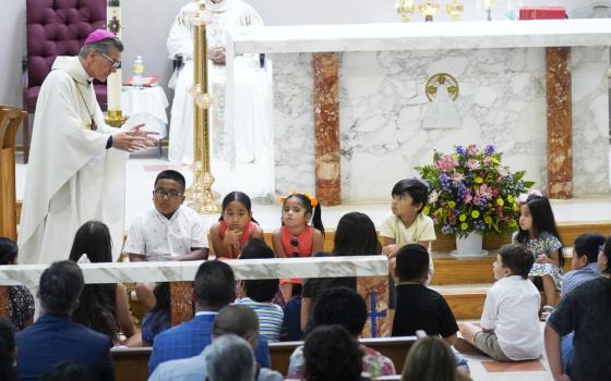 San Antonio Archbishop Gustavo García-Siller talks with children as President Joe Biden and First Lady Jill Biden attend Mass at Sacred Heart Catholic Church, after a school shooting May 29 in Uvalde, Texas. (AP/Evan Vucci)