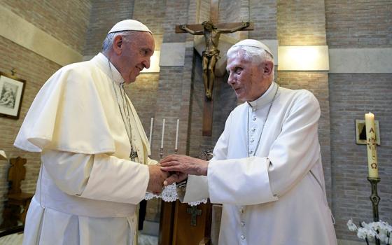 In 2017, Pope Francis, left, and Pope Emeritus Benedict XVI meet on the occasion of the elevation of five new cardinals at the Vatican. (RNS/Pool photo via AP, File/L'Osservatore Romano)