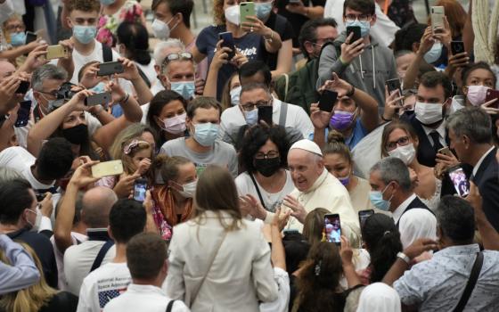 Pope Francis stops to greet the faithful as he leaves after the Aug. 25 weekly general audience at the Vatican. (AP/Gregorio Borgia)