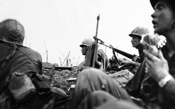 In a photo taken by French photojournalist Catherine Leroy, U.S. Marines get ready for a final assault on a hilltop in northwestern Vietnam on May 3, 1967. (AP/Catherine Leroy)