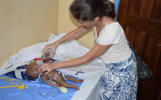 Maryknoll Lay Missioner Anne Berry demonstrates emergency care in the skills lab at Bukumbi Hospital's maternity ward in Tanzania.