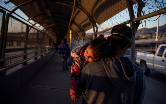 A Honduran immigrant near El Paso, Texas, who is affected by the U.S. Migrant Protection Protocols, better know as the "Remain in Mexico" program, walks back to Ciudad Juarez, Mexico, April 20, after U.S. Customs and Border Protection changed his family's