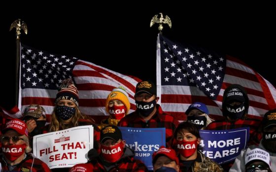 Supporters of President Donald Trump hold signs and wear face masks during a campaign rally at Duluth International Airport in Duluth, Minnesota, Sept. 30. (CNS/Reuters/Leah Millis)