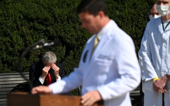 White House Chief of Staff Mark Meadows, left, sits outside Walter Reed National Military Medical Center in Bethesda, Maryland, Oct. 4, as Dr. Sean Conley, a Navy commander who is the White House physician, speaks to the media about President Donald Trump