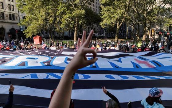 Supporters of President Donald Trump march in New York City Oct. 21. The hand in the foreground is making a gesture used by those on the right and sometimes by extremists or white supremacists. It was added to the Anti-Defamation League's symbols database