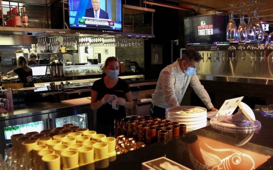 People in Miami work at a restaurant Aug. 31, 2020, during the coronavirus pandemic. (CNS/Reuters/Marco Bello)