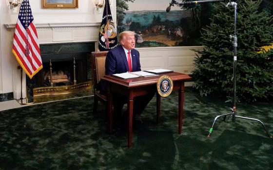 President Donald Trump participates in a Thanksgiving video teleconference with members of the military forces, at the White House in Washington Nov. 26. (CNS/Reuters/Erin Scott)