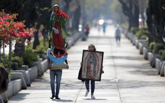 Pilgrims carry a statue and image of Our Lady of Guadalupe near the basilica in her name in Mexico City Dec. 12, 2020, during the COVID-19 pandemic. The basilica was closed that day to avoid crowds during Our Lady of Guadalupe feast day celebrations. (CNS