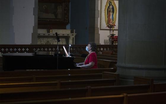 Patricia Burkhardt rehearses prior to Mass at St. Gabriel Catholic Church in Washington July 11. (CNS/Tyler Orsburn)