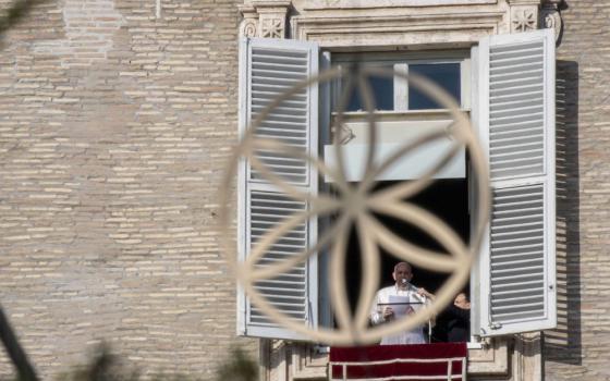 Pope Francis is pictured through an ornament on the Christmas tree as he leads the Angelus from the window of his studio overlooking St. Peter's Square at the Vatican Dec. 20. (CNS/Vatican Media)