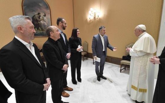 Pope Francis greets filmmaker Evgeny Afineevsky and others involved with the production of the documentary, "Francesco," before the papal general audience at the Vatican Oct. 21. (CNS/Vatican Media)