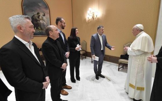 Pope Francis greets filmmaker Evgeny Afineevsky and others involved with the production of the documentary, "Francesco," before the papal general audience at the Vatican Oct. 21. (CNS/Vatican Media)