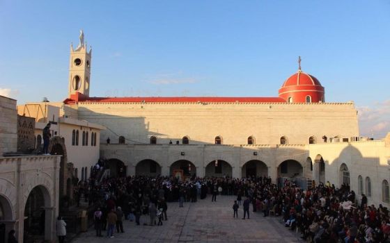 Crowds surround Cardinal Pietro Parolin, Vatican secretary of state, Dec. 28, 2018, as he visits the Syriac Catholic cathedral, St. Mary al-Tahira, in Qaraqosh, a city in the Ninevah Plains, where some 100,000 Christians were uprooted in 2014 by Islamic S