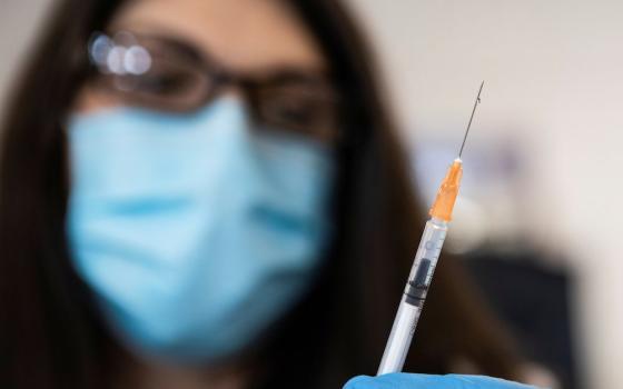 A nurse in Richmond, Virginia, readies a syringe with the COVID-19 vaccine at the Richmond Raceway complex March 4, 2021. (CNS/Reuters/Julia Rendleman)