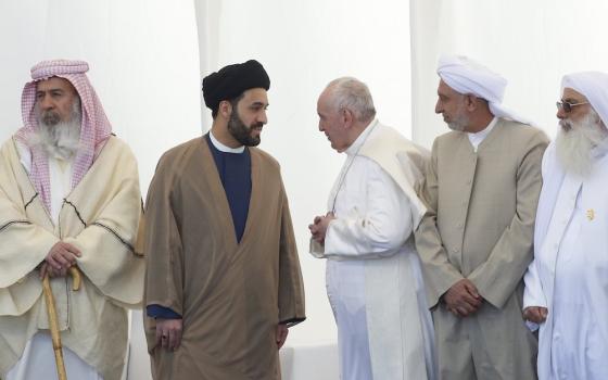 Pope Francis talks with a religious leader during an interreligious meeting on the plain of Ur near Nasiriyah, Iraq, March 6, 2021. (CNS/Paul Haring)