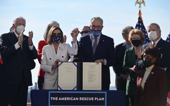 House Speaker Nancy Pelosi, D-Calif., and Senate Majority Leader Chuck Schumer, D-N.Y., display the "American Rescue Plan" March 10, 2021