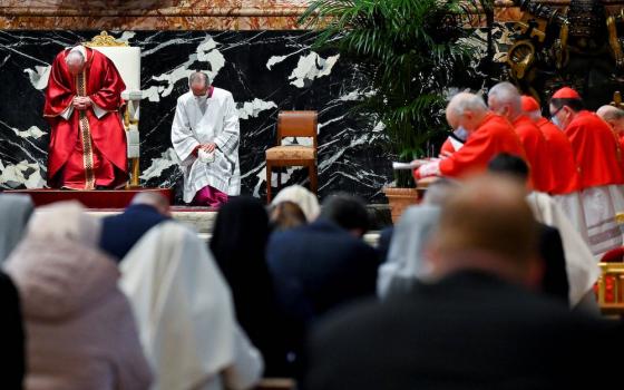 Pope Francis, left, prays as he leads the Good Friday Liturgy of the Lord's Passion April 2, 2020, at the Altar of the Chair in St. Peter's Basilica at the Vatican. (CNS/Reuters pool/Andreas Solaro)