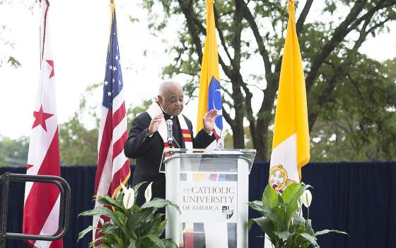 Washington Archbishop Wilton Gregory blesses the "Angels Unawares" sculpture at The Catholic University of America in Washington Sept. 27. (CNS/Tyler Orsburn)