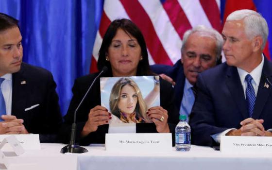 Sen. Marco Rubio, R-Florida, and Vice President Mike Pence listen to Maria Eugenia Tovar Aug. 23 at Our Lady of Guadalupe Church in Doral, Florida, as she holds a picture of her daughter who was killed in 2014 during a protest in Venezuela.