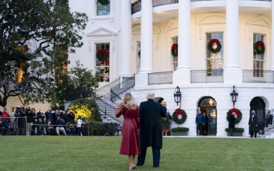 President Donald Trump and first lady Melania Trump wave to guests and members of the press as they walk across the South Lawn of the White House Dec. 5, before boarding Marine One to begin their trip to Georgia. (Flickr/White House/Tia Dufour)