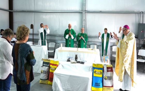 Bishop Brendan J. Cahill of Victoria, Texas, blesses samples of seed and soil in Ganado, Texas, Jan. 15. (CNS/The Catholic Lighthouse/Janet Jones)