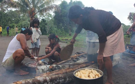 Urarina women prepare breakfast in Santa Lucía, on the Urituyacu River in northeastern Peru. (NCR photo/Barbara Fraser)