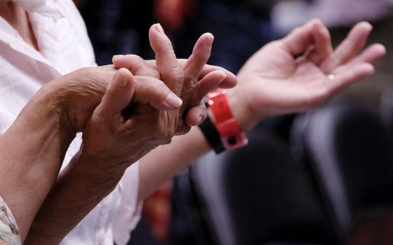 Catholics hold hands during a 2016 Mass in Sioux City, Iowa. (CNS/Catholic Globe/Jerry L. Mennenga)