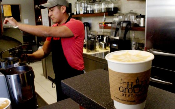 Paco Orocco, 25, creates a work of art on each coffee at Holy Grounds at St. Monica Catholic Community in Santa Monica, California. All the baristas the church hires for the café are formerly incarcerated youth. (Heather Adams)