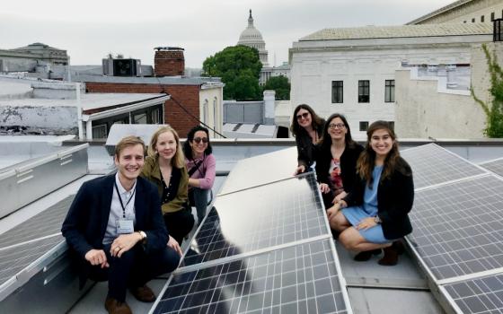 Members of Interfaith Power & Light pose near the solar panels on the roof of the Lutheran Church of the Reformation in Washington, D.C. (Interfaith Power & Light)