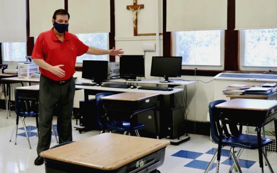 Principal Robert Chevrier shows off a socially distanced sixth-grade classroom at St. Joseph School in Medford, Massachusetts, July 28. Soon the desks will all have plastic dividers as well. (Alexander Thompson)