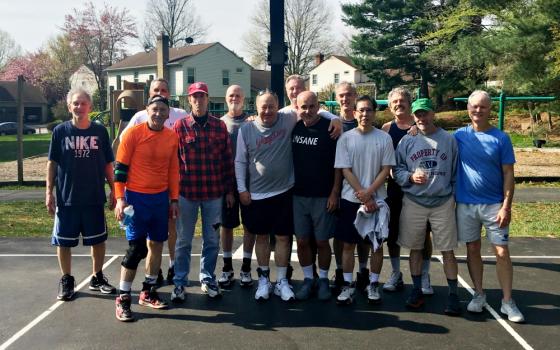 Jack McHale (center, black shirt) with friends at their weekly Sunday morning basketball games. McHale has recruited many of the men from these games to join on his trips into D.C. over the years. (Provided photo)