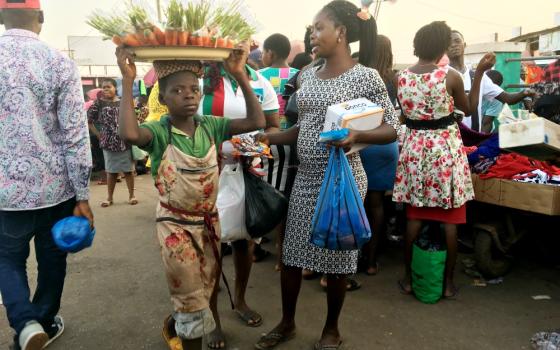 A child hawks carrots at a market in Enugu State, Nigeria. (Patrick Egwu)