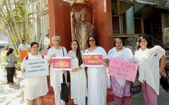 Several of the signatories of the petition to Cardinal Oswald Gracias of Mumbai, India, stand together in front of a statue of Pope John Paul II near Mumbai's Holy Name Cathedral March 8. (Courtesy of Astrid Lobo Gajiwala)