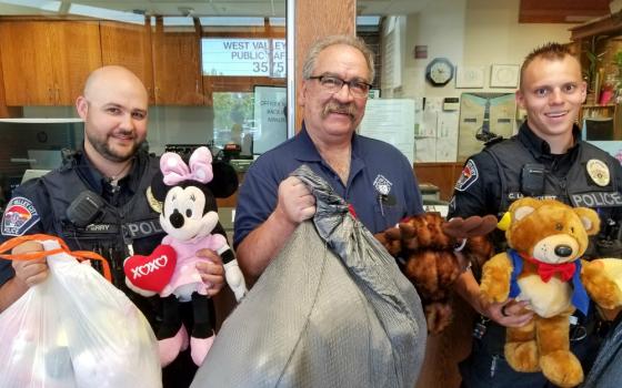 Utah Knights of Columbus 4th Degree District Marshall Richard Vigor, center, is flanked by members of the West Valley City Police Department following the Knights’ collection drive for stuffed animals for traumatized children. (Courtesy of Andy Airriess)