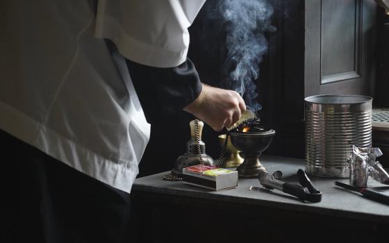 An altar server prepares a censer for use during a traditional Latin Mass July 1, at Immaculate Conception Seminary in Huntington, New York. (CNS/Gregory A. Shemitz)