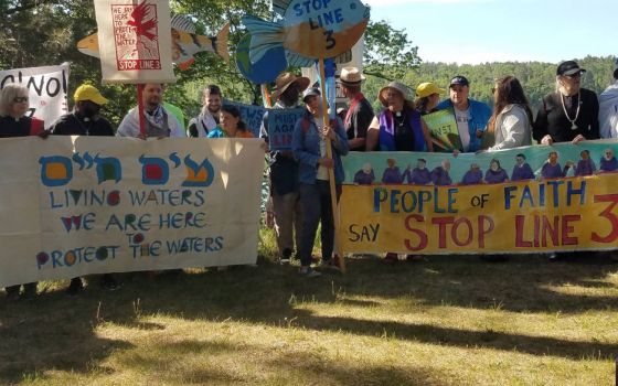 A multi-faith delegation prays before a march and rally opposing the Enbridge Line 3 pipeline near the Mississippi headwaters in northern Minnesota in early June. (Marianne Comfort)