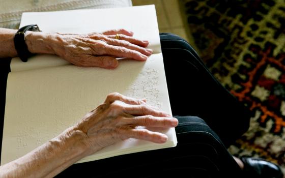 Cuban-American Adelina Maideski reads Braille Catholic materials in early May at her residence in Coconut Creek, Florida. (CNS/Tom Tracy) 