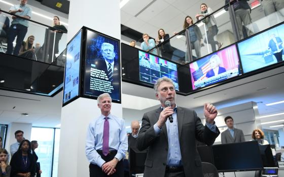 Executive Editor Martin Baron, holding microphone, speaks to staff at The Washington Post in this undated photo. (Courtesy of The Washington Post)